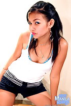 Long hair past her shoulders wearing white top in black shorts