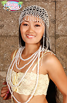 Wearing beads around her neck in yellow bra