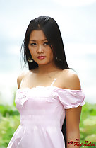 Long hair over her shoulders wearing pink dress