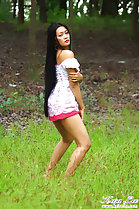 In field wearing dress long hair down her back