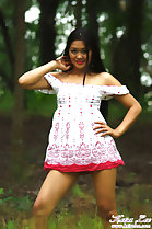 Standing with hand on hip wearing dress