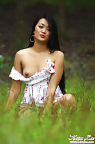 Keira Lee squatting in field long hair small breast exposed