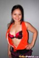 Top unzipped to reveal her bra hand on hip