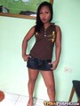 Wearing brown top and denim shorts long hair hands on hips