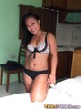 Kneeling on bed wearing bra and panties long hair