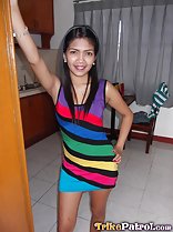 Standing in doorway wearing colourful striped dress hand on hip