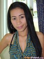 Standing beside window long hair over her striped top