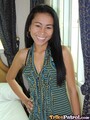 Alma with her hand on hip wearing striped top long hair