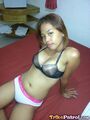 Sitting on bed in bra and panties